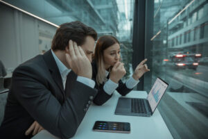 Deux professionnels vérifient la conformité IA dans un bureau moderne